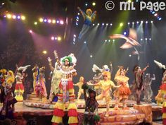 a group of people standing on top of a stage in front of an audience at a circus