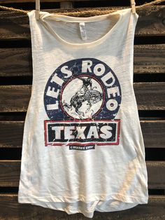 Country Deep Let's Rodeo 1986 Vintage Texas rodeo muscle tank top available in Natural color Country Deep Muscle Tank s 90% combed and ring-spun cotton/10% polyester Side-seamed Relaxed, drapey fit Low cut armhole Curved bottom hem Sizes: S-2XL Texas Rodeo, Muscle Tank Top, Country Shirts, Scoop Neck Tank Top, Muscle Tank Tops, T Shirt Photo, Muscle Tank, Muscle Tanks, Muscle Tees