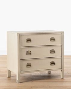 a white chest of drawers sitting on top of a wooden floor