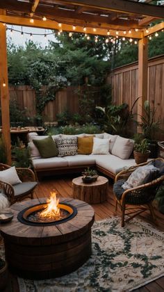 an outdoor living area with fire pit, couches and lights hanging from the ceiling