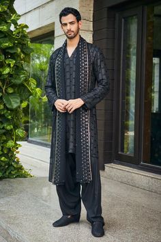 Black kurta with all-over chikankari and sequin embroidery. Comes with matching dupatta and salwar.
Components: 3
Pattern: Embroidered
Type Of Work: Chikankari, Sequins
Neckline: Stand Collar
Sleeve Type: Straight Full
Fabric: Kurta and Dupatta- Georgette, Salwar- Rayon
Color: Black
Other Details: 
Model height: 6ft, wearing size M
Occasion: Sangeet - Aza Fashions Engagement Dress For Men, Dandiya Night, India Fashion Men, Men Aesthetic Outfits, Sangeet Ceremony, All Black Suit, Mens Indian Wear, Wedding Kurta, Wedding Kurta For Men