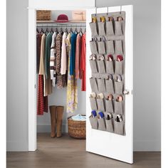 an open closet with several pairs of shoes hanging on the door and one person's boots