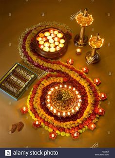 an arrangement of candles and decorations for diwaling on the floor - stock image