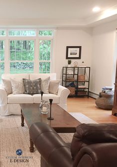 a living room filled with furniture and lots of window sill space in front of it