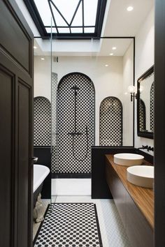 a bathroom with black and white tiles on the floor