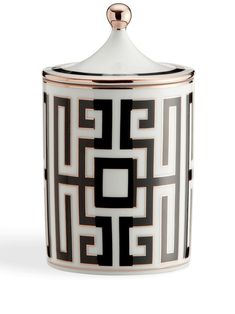 a black and white canister with gold accents