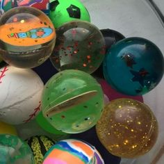 a bowl filled with lots of different colored balls