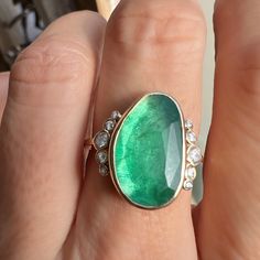 Holy Moly this is a RING. A stunning rosecut Zambian Emerald is set in buttery 14k yellow gold. Accented with over 1/4th of a ct of Brilliant white diamonds and Emily's seagrass band this is truly a ring that will be forgotten. Approx stone size: 18mm x 11mm Approx ct weight: 4.7cts Approx diamond ct: .26cts Mohs hardness: 8 This one of a kind piece is handmade with love in Emily's Hudson Valley studio. It is currently in stock and ready to size and ship. If you have questions about sizing, ship Oval Emerald Ring With Single Cut Diamonds, Oval Emerald Ring With Rose Cut Diamonds, Fine Jewelry Rose Cut Diamonds Ring For May Birthstone, Fine Jewelry Rose Cut Diamond Rings For May Birthstone, Heirloom Oval Emerald Ring With Single Cut Diamonds, May Birthstone Rose Cut Diamond Ring, Oval Emerald Ring With Rose Cut Diamonds For Anniversary, Rose Cut Diamond Briolette Jewelry For Anniversary, Oval Rose Cut Diamond Rings For May Birthstone