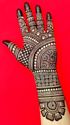 a hand with henna tattoos on it