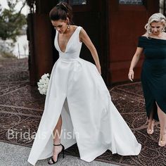 a woman in a black and white dress is walking towards the camera with another woman