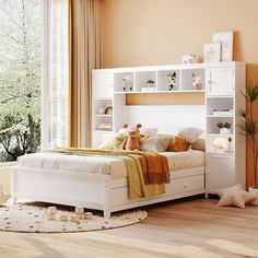 a white bed sitting in a bedroom next to a window