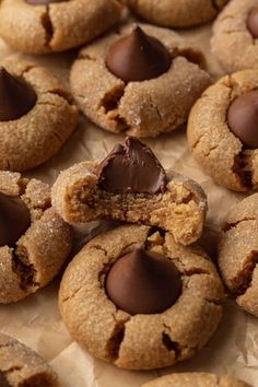 chocolate chip cookies on parchment paper with one broken in half