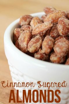 cinnamon sugared almonds in a white bowl on a wooden table with text overlay