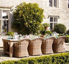 an outdoor dining table with wicker chairs