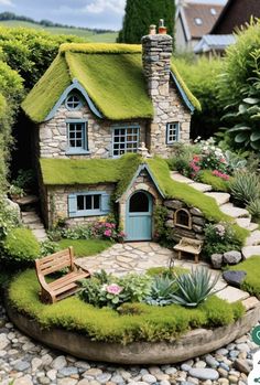 a miniature house made out of moss and rocks with a bench in the front yard