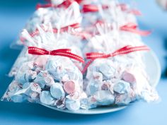 white chocolate candies wrapped in red ribbon on a plate