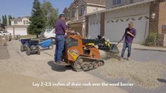 two men are working in front of their house with a small snow blower on the sidewalk