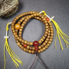 ❤ This old lotus seed mala was handmade from tibetan crafts man in Baiyu County,about 20 years old. It's composed of 108 lotus seed beads,then add some agate beads,1 pair of silver bead counters,and agate guru bead on it.❤Details:Mala'perimeter is 58cm,23 inches.108 lutus seed beads approximately 6mm,0.24 inch.1 × yellow agate main bead diameter 12mm/ 0.31 inch.2 × small red agate spacer beads diameter 8mm / 0.32 inch.1 × agate guru bead,10mm × 20mm / 0.4 × 0.8 inch.1 pair of silver bead counter Tibetan Lotus, Lotus Sutra, Lotus Seed, Yellow Agate, Beads Mala, Green Tara, The Monks, Red Agate, Silver Bead