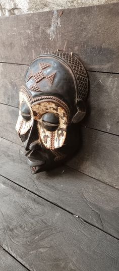 an old leather mask is hanging on the wall