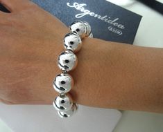 Brand: Argentidea Jewelry Instagram: https://www.instagram.com/gioielli_argentidea/ Size: 21cm (19.5 to 21cm extension chain) Weight: 40g. Silver colour Classic and eye-catching women's bracelet, in 925 silver, with smooth spheres. The spheres have a diameter of 14 mm. The bracelet features an oval lobster clasp. The bracelet is the natural color of silver, manually polished to a shiny finish. A completely handcrafted jewel, conceived, designed, produced and finished entirely by hand by master goldsmiths in our laboratory in Arezzo in Tuscany. By purchasing silver jewelery directly from the manufacturer you will have an excellent weight/price/quality ratio. All our items will be shipped together with a logo jewelry box and a logo box carrier bag. All shipments will be made with internation Logo Jewelry, Handcrafted Silver Jewelry, Jewelry Instagram, Ball Bracelet, Silver Colour, Ball Chain, Chain Link Bracelet, Link Bracelets, Womens Bracelets