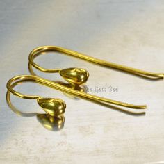 Thank you for coming in! Classic 18K solid gold earwires with fun raindrop ends, pretty and economical 18k gold earwires. The wire measures 0.8mm, 20 gauge. You'll get a pair of earwires per winning! SIZE: 11mmx21mm Weight: 0.65 grams (approx) MATERIAL: 18k Solid gold Adjustable Gold Teardrop Earrings With Ear Wire, Adjustable Gold Teardrop Earrings, Yellow Gold Teardrop Earrings With French Hook, Nickel-free Yellow Gold Teardrop Earrings, Gold Minimalist Teardrop Earrings With Lever Back, Yellow Gold Teardrop Earrings With Lever Back, Yellow Gold Teardrop Earrings, The Wire, Rain Drops