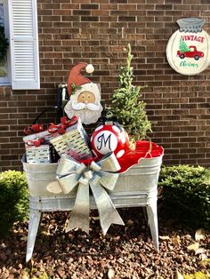 a metal tub filled with christmas items next to a brick wall