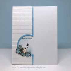 a white card with a blue border and an animal on it