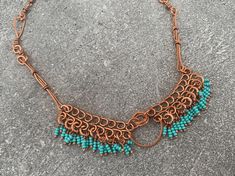 This gorgeous beaded fringe collar bib necklace features intricate wire wrapped details in high-quality pure copper. All components are 100% handmade for a unique statement necklace found nowhere else. This style reflects Southwestern and tropical vibes-- an Art Nouveau-inspired design borrowing ornate filigree accents and organic shapes that give it a vintage feel. Flaunt this beautiful fresh boho look to compliment your style and elevate any outfit. Give as a memorable unique gift to the favorite woman in your life:  For Mother's Day, anniversary presents, Christmas gifts, birthday gifts, graduation and bachelorette parties. ## Sizing Total length is 18 inches. ## Materials Every item is 100% handmade and one-of-a-kind. The wire-wrapped raw copper jewelry is oxidized and polished to beau Bohemian Turquoise Choker For Summer, Adjustable Bohemian Copper Necklace, Bohemian Wire Wrapped Choker For Festivals, Copper Wire Wrapped Necklace For Festivals, Festival Wire Wrapped Copper Necklaces, Festival Copper Wire Wrapped Necklaces, Festival Wire Wrapped Copper Necklace, Festival Copper Wire Wrapped Necklace, Bohemian Wire Wrapped Copper Wire Necklaces