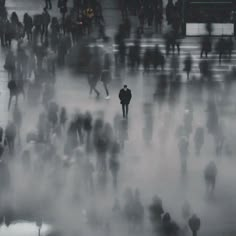 many people are walking around in the fog