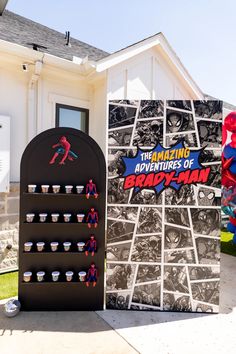 the amazing adventures of spider - man display in front of a house with posters on it