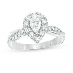 a pear shaped diamond engagement ring with diamonds on the band and shoulders, set in 18k white gold