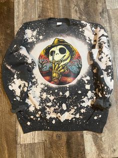 a black and white sweater with a skull on it