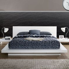 a modern bedroom with black and white decor on the bed, nightstands and night stands