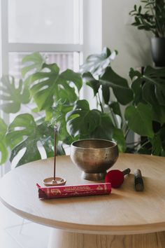 a wooden table topped with a metal bowl