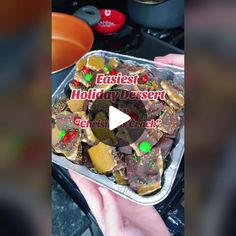 a person holding a tray of food on top of a stove with the words eusiest and holiday dessert