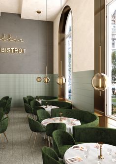 the interior of a restaurant with green chairs and tables