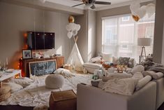 a living room filled with furniture and balloons