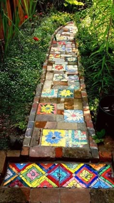 a walkway made out of bricks and painted with different colors