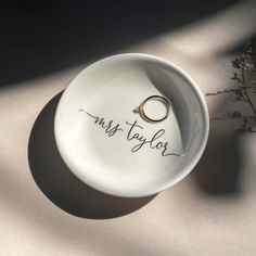 a ring dish with the word miss taylor written on it