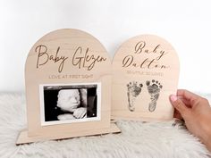 two wooden photo frames with baby's footprints on them