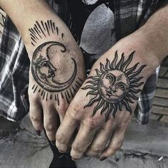 two hands with sun and moon tattoos on their palms, one holding the other's hand