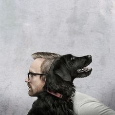 a man with glasses and a black dog on his shoulders looking up at something in the air