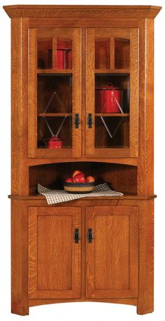 a wooden hutch with glass doors and cupboards