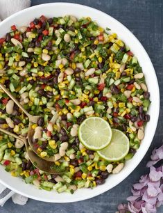 a white bowl filled with black eyed peas, corn, and avocado salad