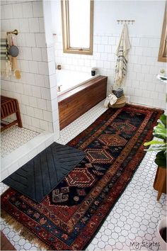 a bath room with a rug on the floor