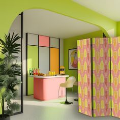 a room divider in the middle of a room with green walls and pink furniture