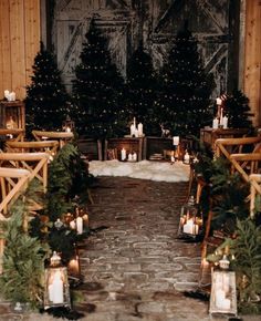 an outdoor wedding setup with candles and christmas trees