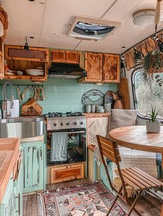 an old camper has been converted into a tiny kitchen and dining area with wood flooring