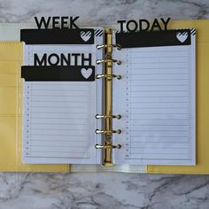 an open planner book with the words week, month and heart stickers on it