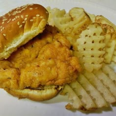 a chicken sandwich and fries on a plate